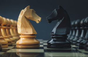 Opposing chess pieces to symbolise the obstacle of marketing compliance
